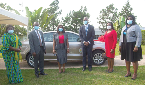  Dignitaries in a group picture, behind them is the new VW polo sedan vehicle