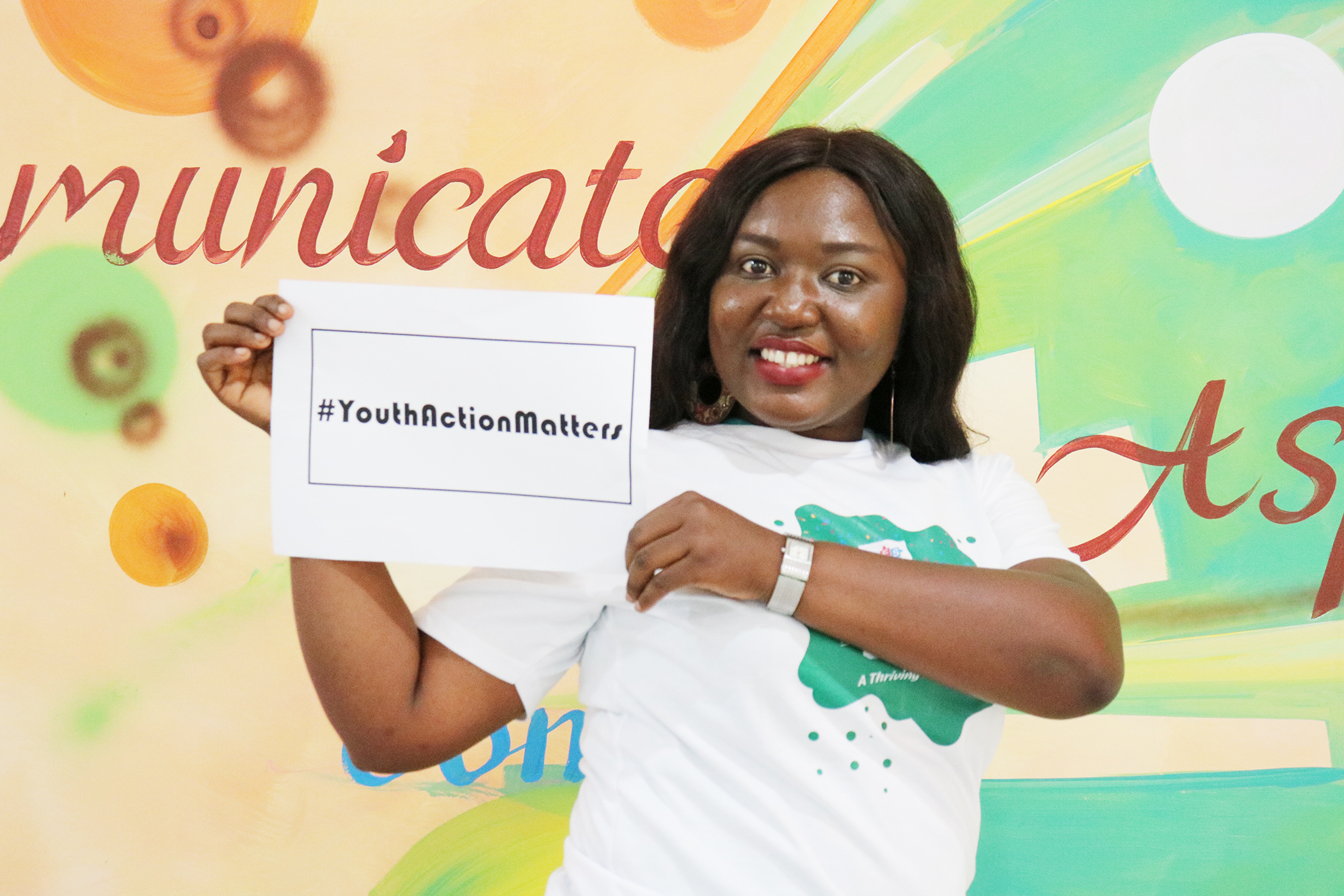 Ms Bridget Biney displaying one of the hash tag placards