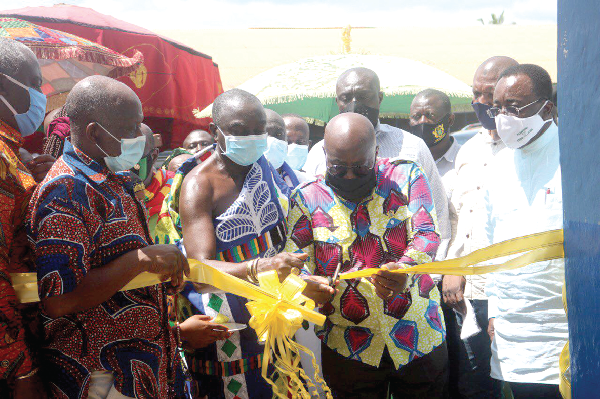 President Akufo-Addo (2nd right), being assisted by the Juasohene, Nana Asafoakwaa Adjei Tabi I (In Kente), to cut the tape to inaugurate the block. Among those with them is Mr Simon Osei-Mensah (left), the Ashanti Regional Minister. Pictures by EMMANUEL BAAH 