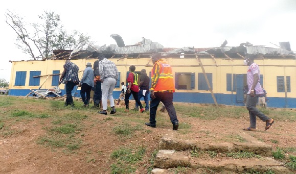 Mr Akwasi Acquah (in hat) and his entourage inspecting the damaged Oda Presbyterian Primary School block 
