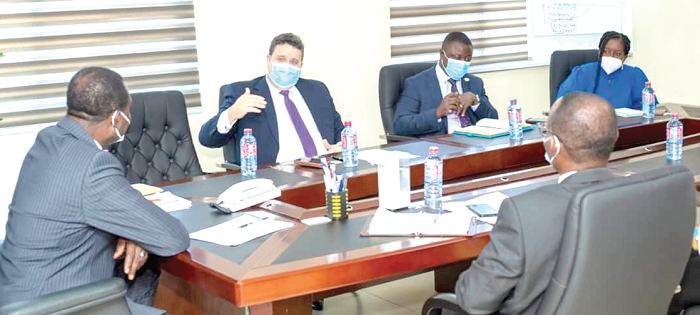 Mr Pierre Laporte (2nd left), the World Bank Country Director, briefing Dr Yaw Osei Adutwum (left) at the meeting 