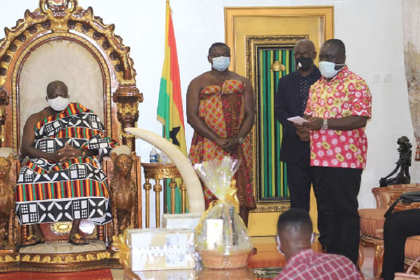 •Otumfuo Osei Tutu II (seated) with Mr Kwaku Ofori Asiamah (right) and his entourage at Manhyia