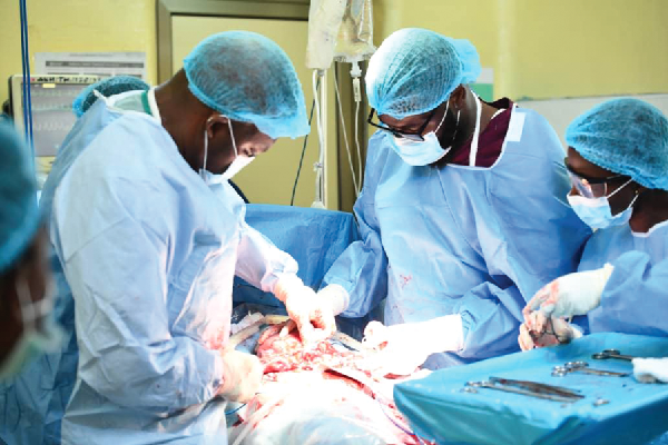  Dr Taurus Valmont (left) leading the team to perform the caesarean sestion procedure