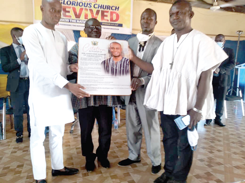 Alhaji Yusif Sulemana, MP for Bole (left), being presented with the citation by Rev Mintah (behind the citation), the vice chairman of the Bole Local Council of Churches. With them are Rev. Fr. Martin Muosayir of the Martyrs of Uganda Catholic Church, Bole (in white smock) and Pastor Adams of Lighthouse Chapel, Bole