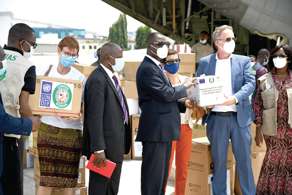  • Mr Christoph Retzlaff (2nd right), the German Ambassador to Ghana, handing over some of the PPE to Dr Kwabena Oku-Afari, the Chief Director of the Ministry of Health. 
