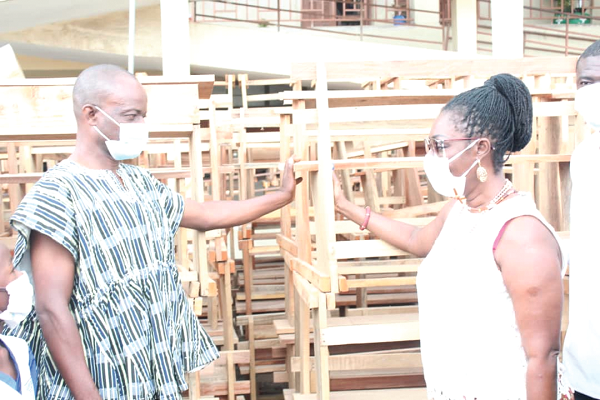 Mrs Ursula Owusu Ekuful (right), MP for Ablekuma West constituency making a donation to Mr Christian J. Aforlah (left), Director of Education for Ablekuma West Constituency. Picture: Patrick Dickson