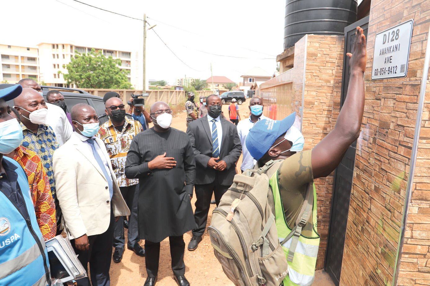 Vice-President Dr Mahamudu Bawumia (3rd right) looking on as a worker of the Land Use Spatial Planning Authority embosses a digital address plate on a building at Adenta. Picture: SAMUEL TEI ADANO 