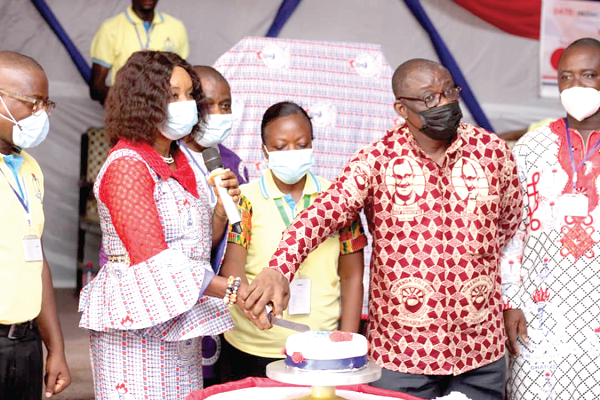 Rev. Dr Isaac Owusu (2nd right), the  Central Regional Chairman of GNAT, being assisted by Mrs Patience Apeku (2nd left), the  KEEA Municipal Chairperson of GNAT, to cut the cake to mark the anniversary