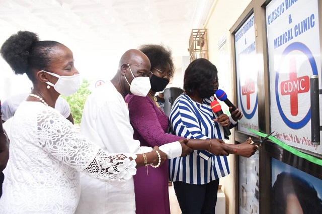 Madam Janet Tulasi Mensah, Ga East Municipal Chief Executive (with scissors), is assisted by Mrs. Juliana Kwabea Quansah, Chief Executive of Classic Diagnostic & Medical Clinic and others to cut the tape to officially inaugurate the health facility