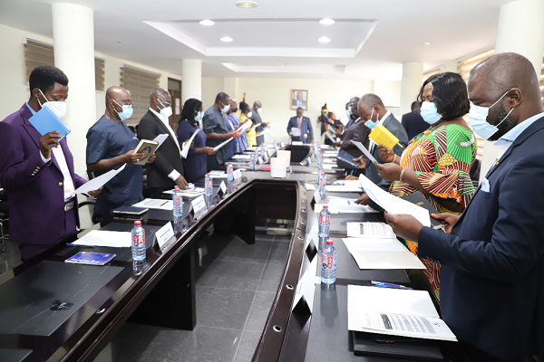 • Mr Francis Asenso-Boakye (head of table), Minister of Works and Housing, swearing in the board members in Accra last Tuesday. 