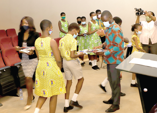 Some officials of the Ghana Book Development Council distributing storybooks to students after the event. Picture: EDNA SALVO-KOTEY