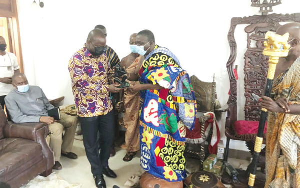  Nana Kobina Nketsia V, the Paramount Chief of Essikado Traditional Area, presenting a gift to Mr Samuel Abdulai Jinapor, the Lands and Natural Resources Minister, after the courtesy call
