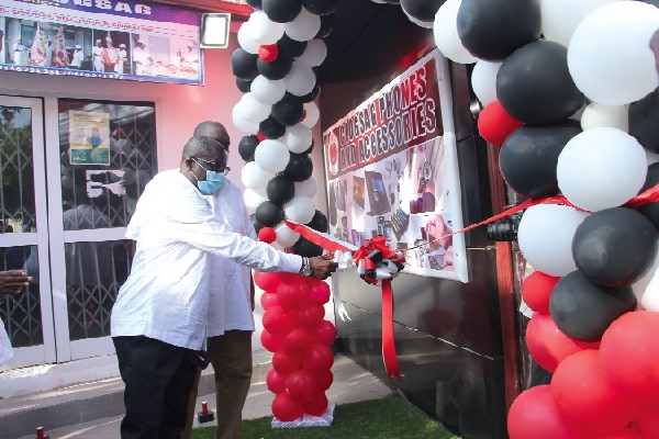 Mr Isaac Bampoe Addo (left), Executive Secretary of CLOGSAG, and Mr Kwame Asamoah Dwomah (right), Director of Complaints and Grievances of the association, cutting the tape to inaugurate the CLOGSAG Technology Shop. Picture: ESTHER ADJEI