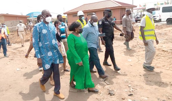  Ms Cecilia Abena Dapaah (2nd left), the Minister of Sanitation and Water Resources, accompanied by Dr Clifford Briamah, MD of GWCL (left), and other officials on an inspection tour at Gbetsile 