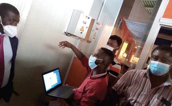 Mr Yaw Kyei Konadu, a technician, taking officials through how the facility works 