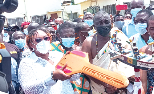 Mrs Mavis Hawa Koomson (left), Minister of Fisheries and Aquaculture Development, turning the dummy key to officially end the close season. With her are Nana Kobina Nketsia V, (2nd right), the Paramount Chief of the Essikado Traditional Area, and some other diginitaries