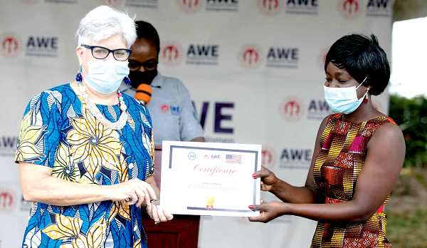 Mrs Stephanie S. Sullivan (left), the United States  Ambassador to Ghana, presenting a certificate to a graduand, Ms Grace Abena Mbro, CEO of Grace Star Fashion Design and Bead-Making in Gomoa Central