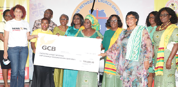 Ms Harriet Wereko-Brobbey (arrowed), President, 1975 Year Group of the Wesley Girls Old Students Association, joined by some of her mates to present a dummy cheque to Dr Hilda Mantebea Boye (2nd left), Vice-President of the Paediatric Society of Ghana. Picture: EDNA SALVO-KOTEY