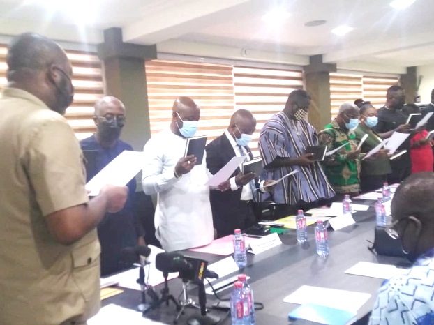 Dr Matthew Opoku Prempeh (left), the Minister of Energy, administering the Oath of Office to the new ECG Board of Directors