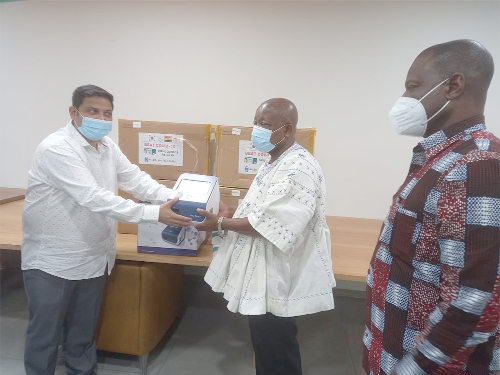 Mr Nilesh Moore (left), Managing Director of NILEX, presenting one of the machines to Mr Kwaku Agyeman-Manu, Minister of Health. Looking on is Dr Patrick Kuma-Aboagye, Director General of the Ghana Health Service
