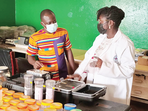 Dr Irene Opoku-Ntim (right), Head of the Nuclear Tracks Detection Lab at the National Nuclear Research Institute, taking our reporter, Edward Acquah, through the testing systems developed at the institute