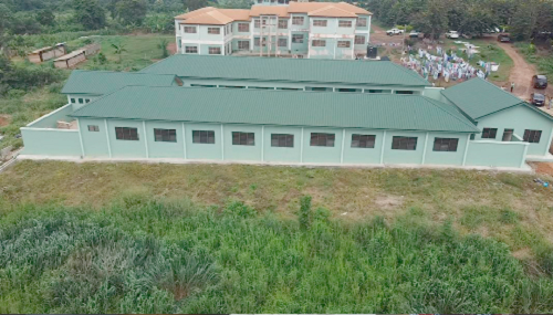 A dormitory block constructed by the authority.  INSET: Mr Joe Danquah, Chief Executive Officer of the MBDA, addressing the media about some of the projects being undertaken by the organisation.