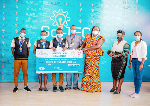 Mrs Nana Akua Ankomah-Asare (2nd right), Managing Director of Primetime Limited, presenting the cheque to the team from the Obuasi Senior High Technical School 