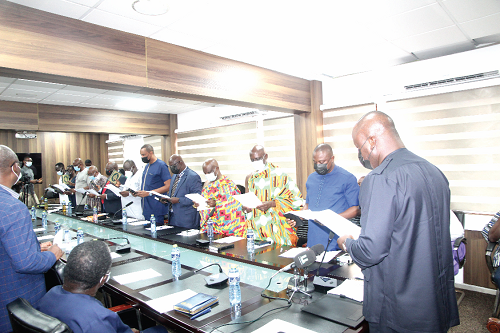 Mr Samuel A. Jinapor (right), Minister of Lands and Natural Resources, swearing  in the new board members of the Forestry Commission. Picture ESTHER ADJEI