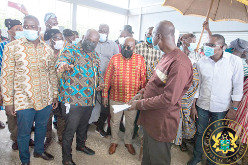 President Akufo-Addo (middle) being briefed on the production processes at the Rice Processing Plant in Savelugu. Inset: The plant