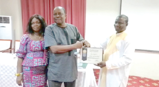 Mr Francis Essel Okyeahene (middle), Director of Young Executive School and Onua Francis School International, receiving the award from Mr Enoch Damson, Headmaster of the Young Executive School. With  them is Mrs Mavis Essel Okyeahene