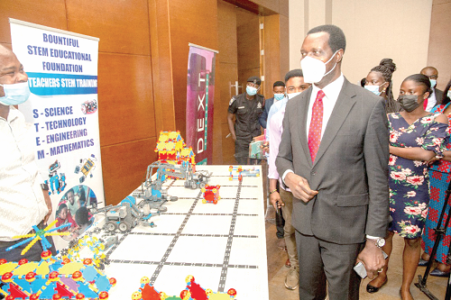 Dr Yaw Osei Adutwum, Minister of Education, inspecting an exhibition mounted at the STEM Education stakeholder meeting in Accra