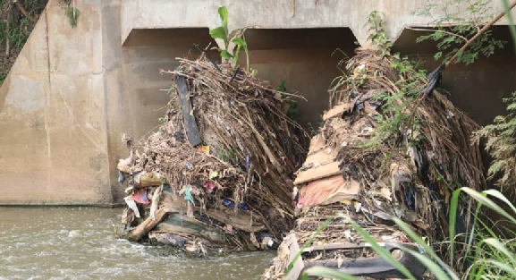 • A pile of rubbish preventing the free flow of water under the Kaase bridge