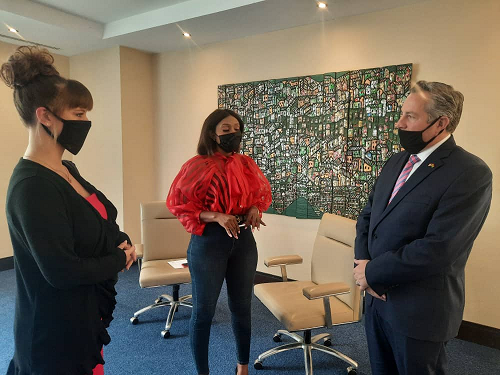 Dr Rollan Roberts, (right) interacting with some journalists after the briefing