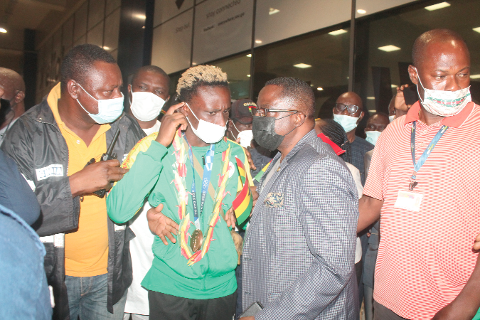 Mr Ben Nunoo Mensah (right), Ghana Olympic Committee President,  conferring with Samuel Takyi at the airport