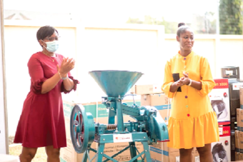 Ms Sally Ofori Yeboah (left), National Director, CAMFED Ghana, presenting a milling machine to one of the beneficiaries