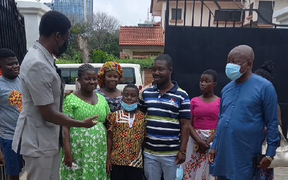 Mr. Kwaku Agyeman-Manu (right), Minister of Health, Nana Kwame Bediako (left), the benefactor, with the family in the house