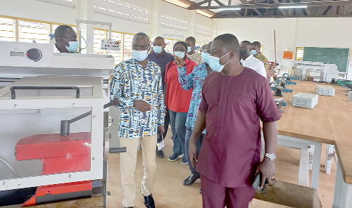 Mr Peter Nortsu-Kotoe, MP for Akatsi North (left), and Mr Fred Asamoah, the Acting Director of Commission on TVET, inspecting some equipment at the Methodist Technical Institute at Kwadaso