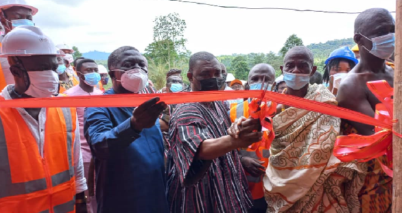 • Mr. George Mireku Duker (middle) being assisted by other dignitaries to cut the tape to inaugurate the community mining site