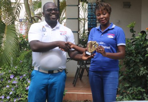 Mr Solomon Oko Allotey receiving his prize from the Public Relations Officer of Latex Foam, Gifty E. Appiah. 