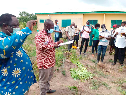 Dr Michael Kwabena Osei (2nd left) with farmers on a demonstration farm at the Agortime-Ziope District Assembly premises