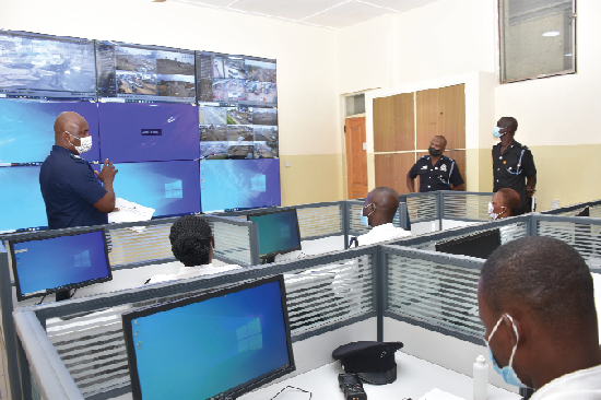 FLASHBACK: Chief Inspector Joseph Zanu (left), General Supervisor of the Motor Traffic Monitoring and Surveillance Centre of the Ghana Police Service, explaining how the monitoring of vehicles is done at the centre 