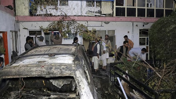 Afghan people are seen inside a house after U.S. drone strike in Kabul, Afghanistan, Sunday, Aug. 29, 2021.
