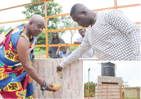  Nana Kwesi Addo II (left), the Akyem Kotoku Mponua Gyasehene, fetching water while Mr. Mark Agyakoo (right), the Unit Committee Chairman of Pankese, opens the tap. INSET: The mechanised borehole