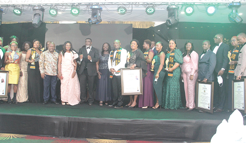 The awardees holding their prizes and citations with invited guests after the ceremony