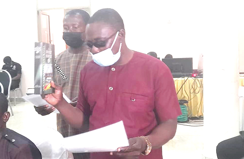Mr Joseph Budu (right) and Mr Ransford Boahen taking their oath when they appeared before the PAC in Sunyani