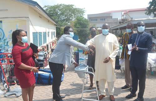 Mr Duke Banson (2nd left), the Country Representative of REACT Humanitarian Network, handing over one of the items to Rev. Fr Prof Afful-Broni (2nd right), UEW VC 