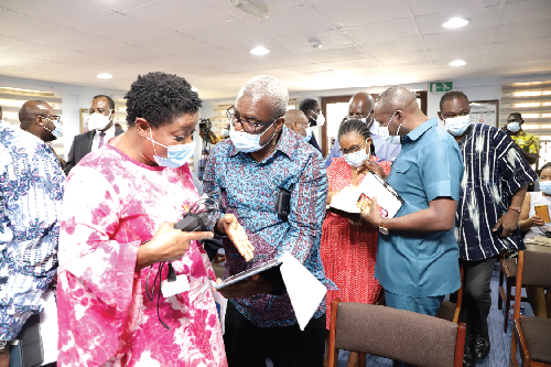 Mr Peter Mac Manu (2nd left), a former National Chairman, NPP, explaining a point to Dr Edem Selormey (left), Director of Research, CDD-Ghana, after the media briefing. Picture: EDNA SALVO-KOTEY