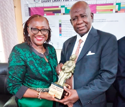 Dr Margaret Opiah (left), Head of Nursing and Midwifery Science Department, UNICAL, presenting a gift to Mr Albert Acquah, Founder of GCUC