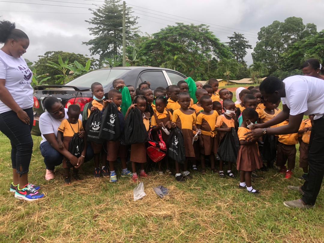 The founder of Naa Maneh Foundation, Ms Lillian Naa Norley Mensah, (squatting) with other members of her team during the donation to the school.