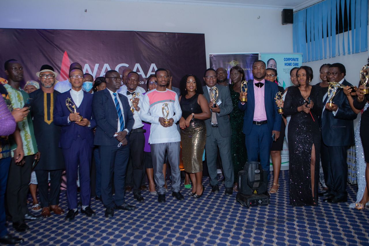 Some award winners displaying their plaques